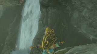A view of a video game character standing next to a waterfall.